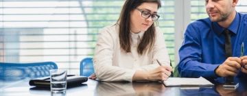 a woman writing on a tablet